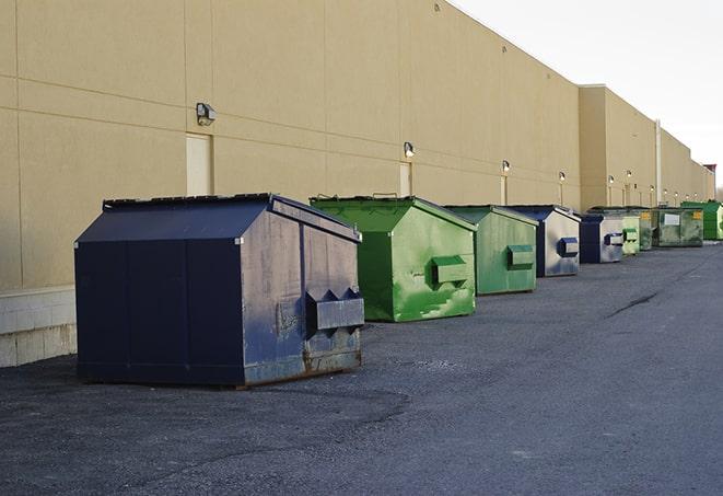 a group of construction workers taking a break near a dumpster in Seville FL